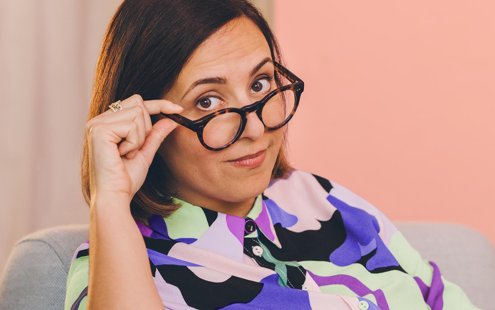 Person lowering their glasses